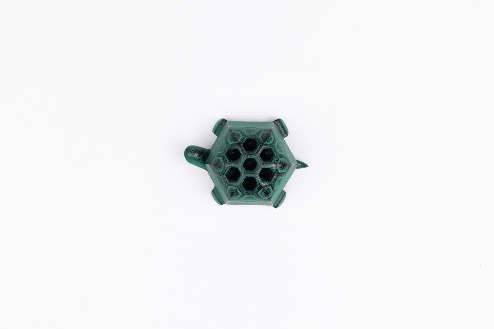 A green cast iron turtle incense holder by Oigen from Japan House London.
