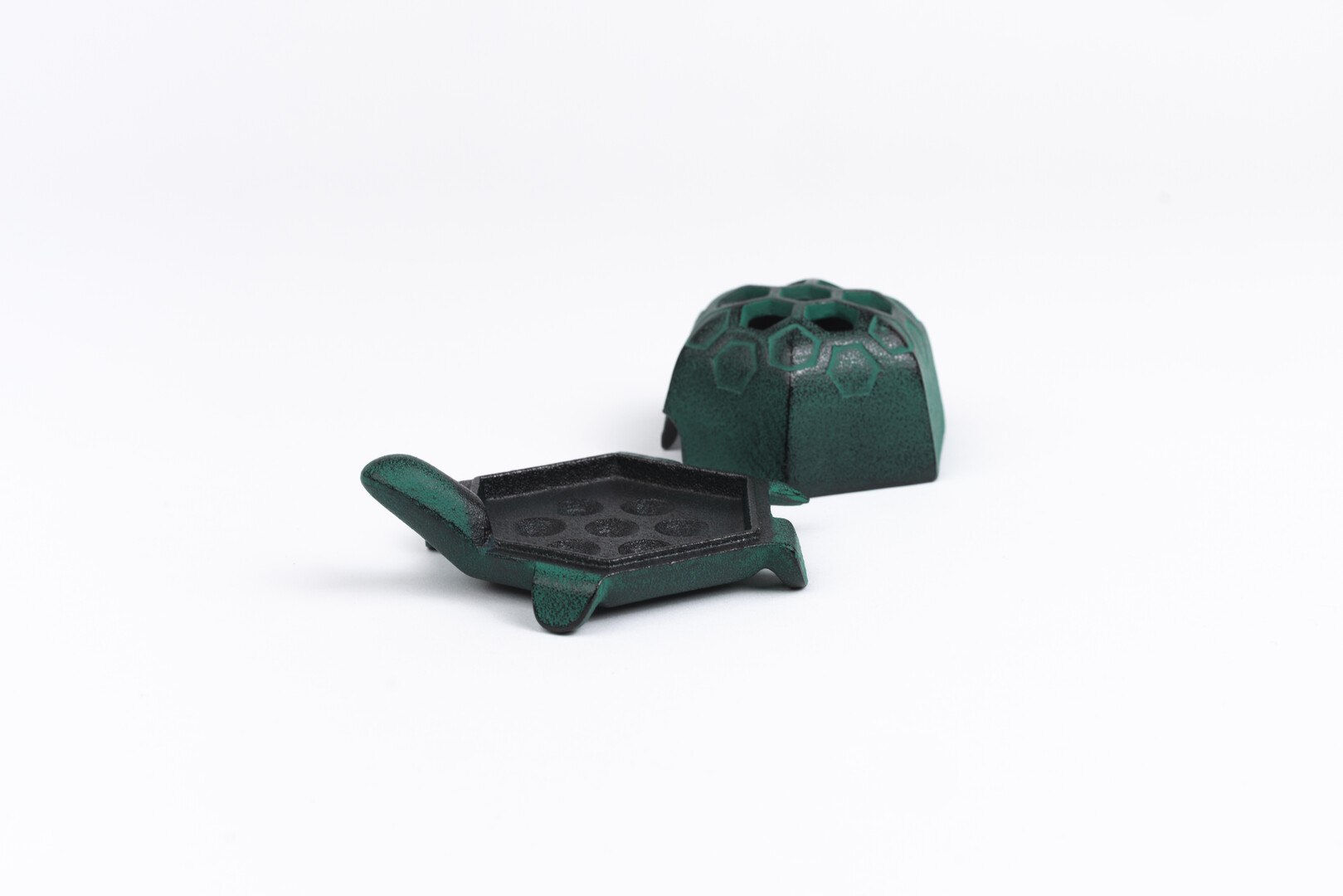 A green cast iron turtle incense holder by Oigen from Japan House London.