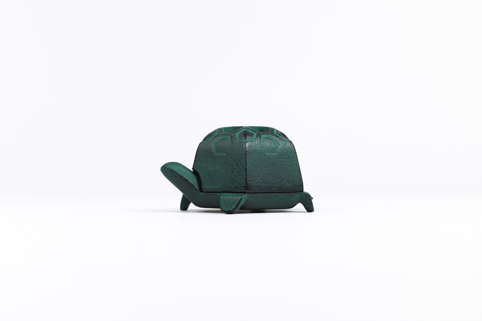 A green cast iron turtle incense holder by Oigen from Japan House London.