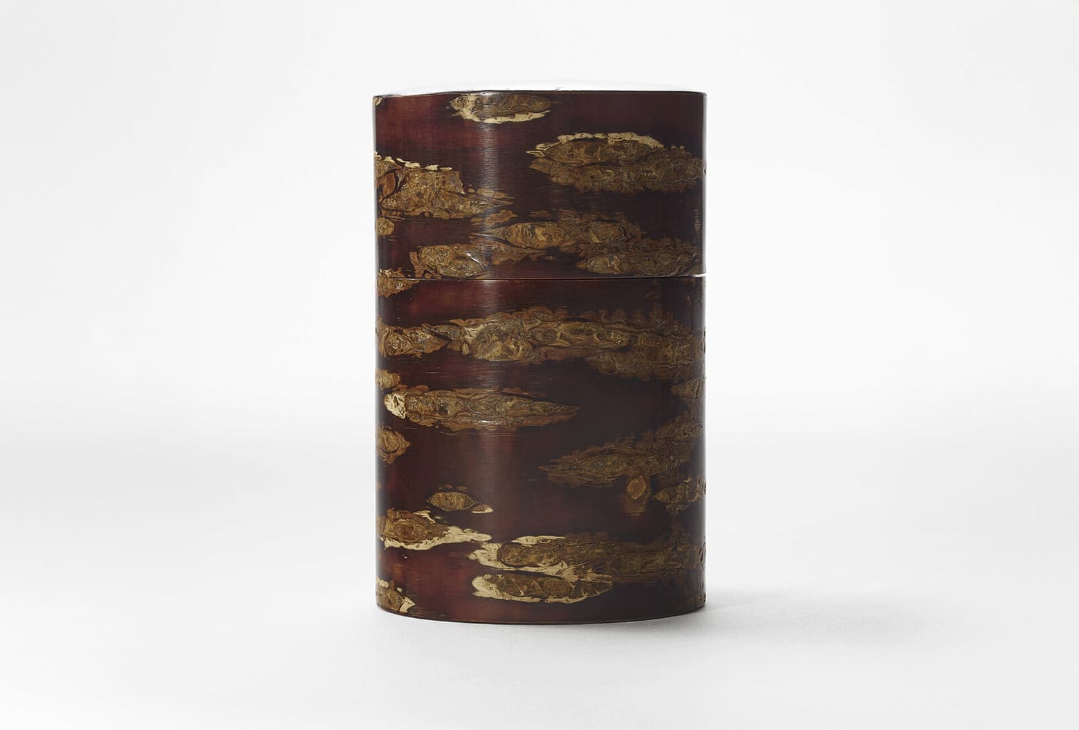 A deep red brown polished cherry bark tea caddy by Tomioka Shoten from Japan House London.
