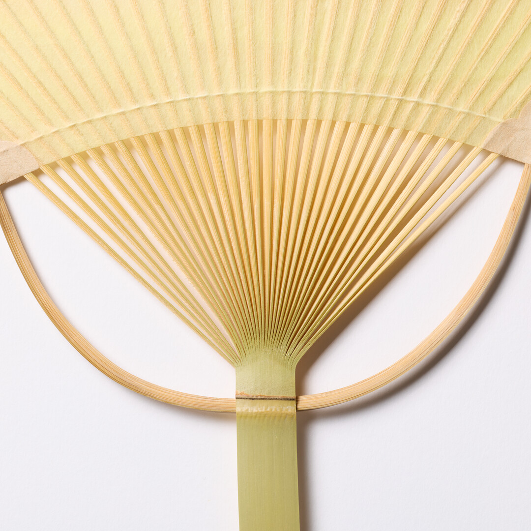 Yellow and orange Japanese Bamboo Paper Oval Fan - Sazanami by Uchiwaya Ryō from Japan House London.
