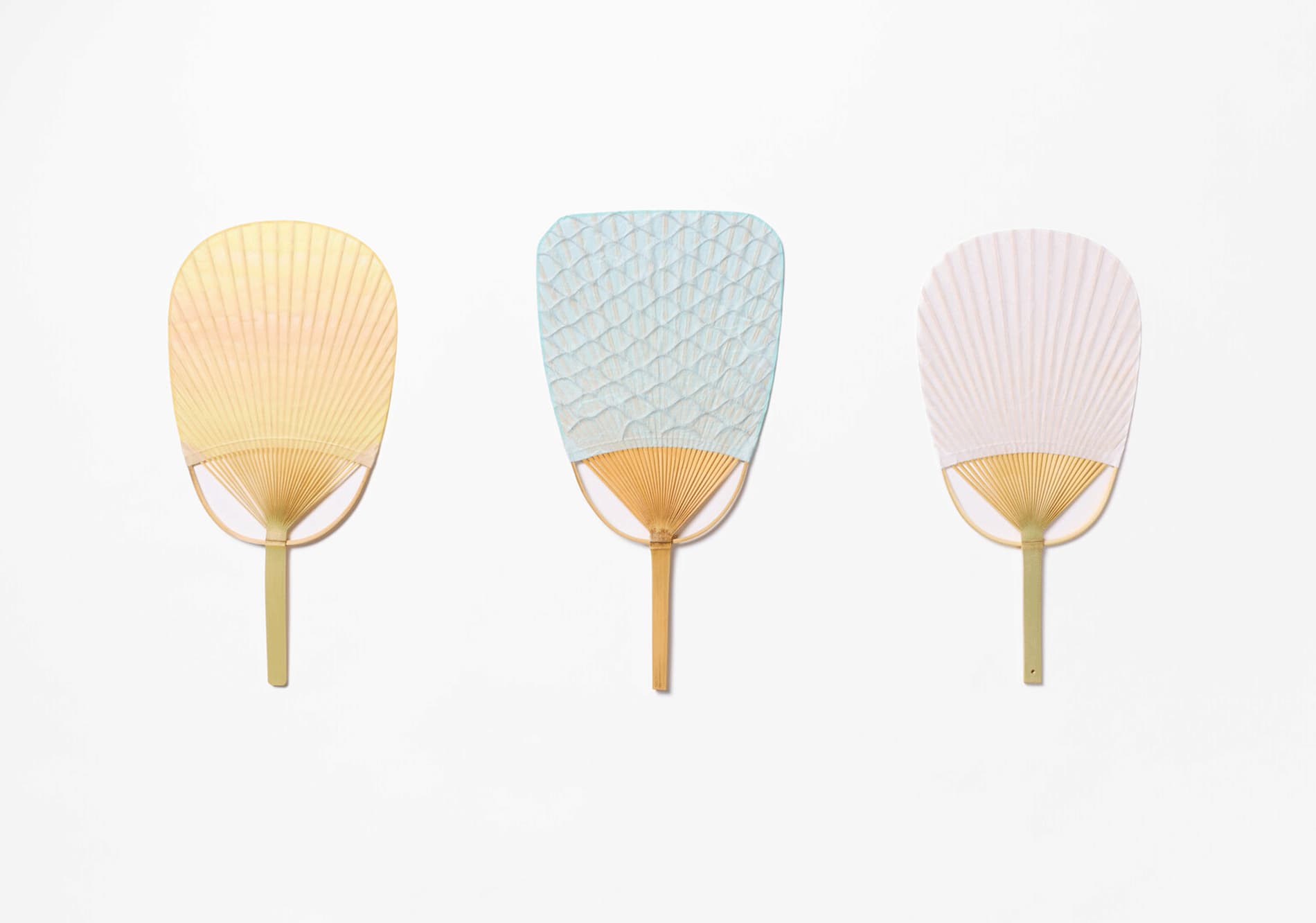 Three fans crafted from washi, in a row made by Uchiwaya Ryō from Japan House London.