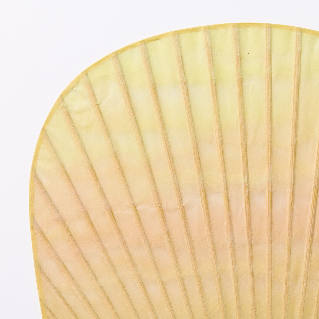 Yellow and orange Japanese Bamboo Paper Oval Fan - Sazanami by Uchiwaya Ryō from Japan House London.