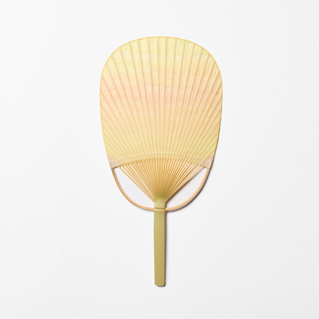 Yellow and orange Japanese Bamboo Paper Oval Fan - Sazanami by Uchiwaya Ryō from Japan House London.