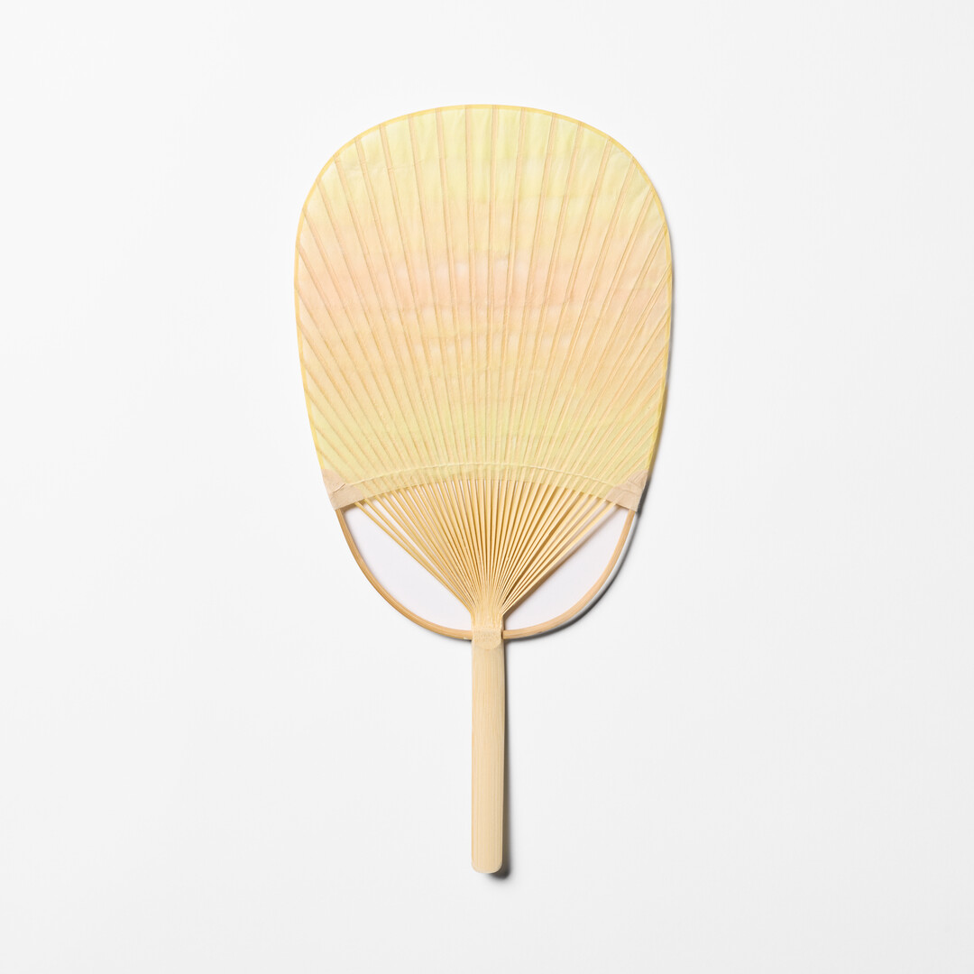 Yellow and orange Japanese Bamboo Paper Oval Fan - Sazanami by Uchiwaya Ryō from Japan House London.