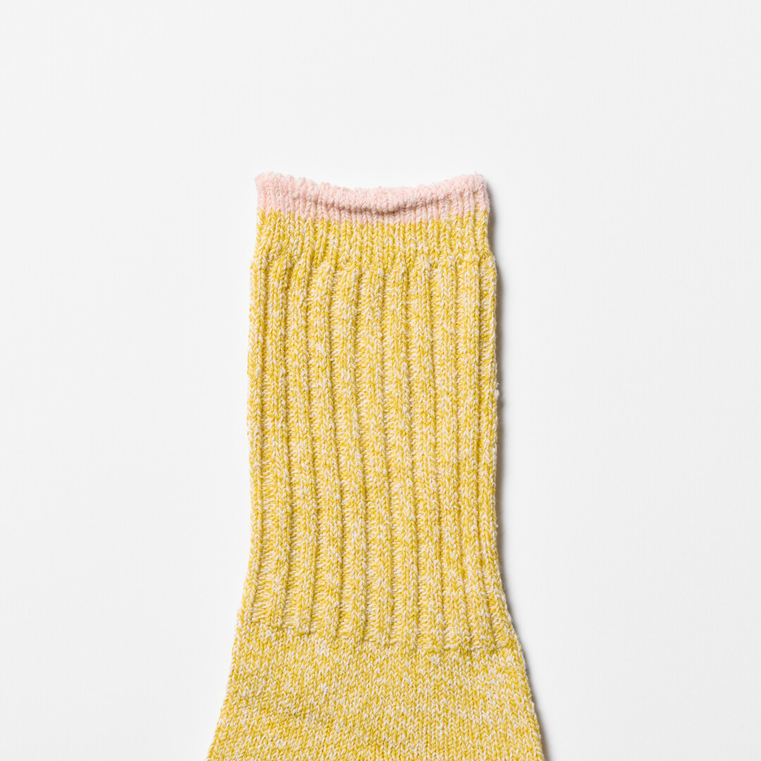 Yellow silk cotton socks with pink trim by Nishiguchi Kutsushita from Japan House London