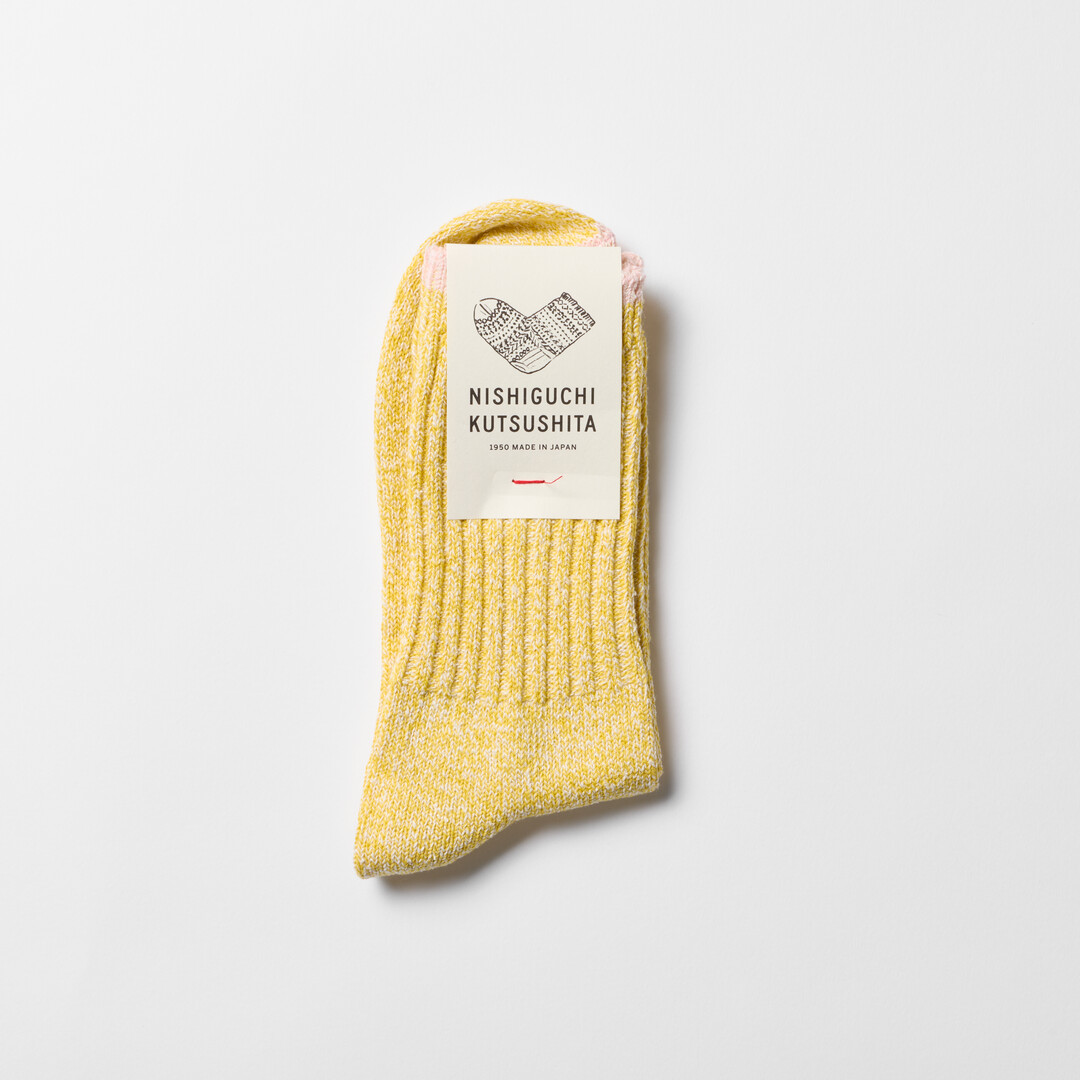 Yellow silk cotton socks with pink trim by Nishiguchi Kutsushita from Japan House London