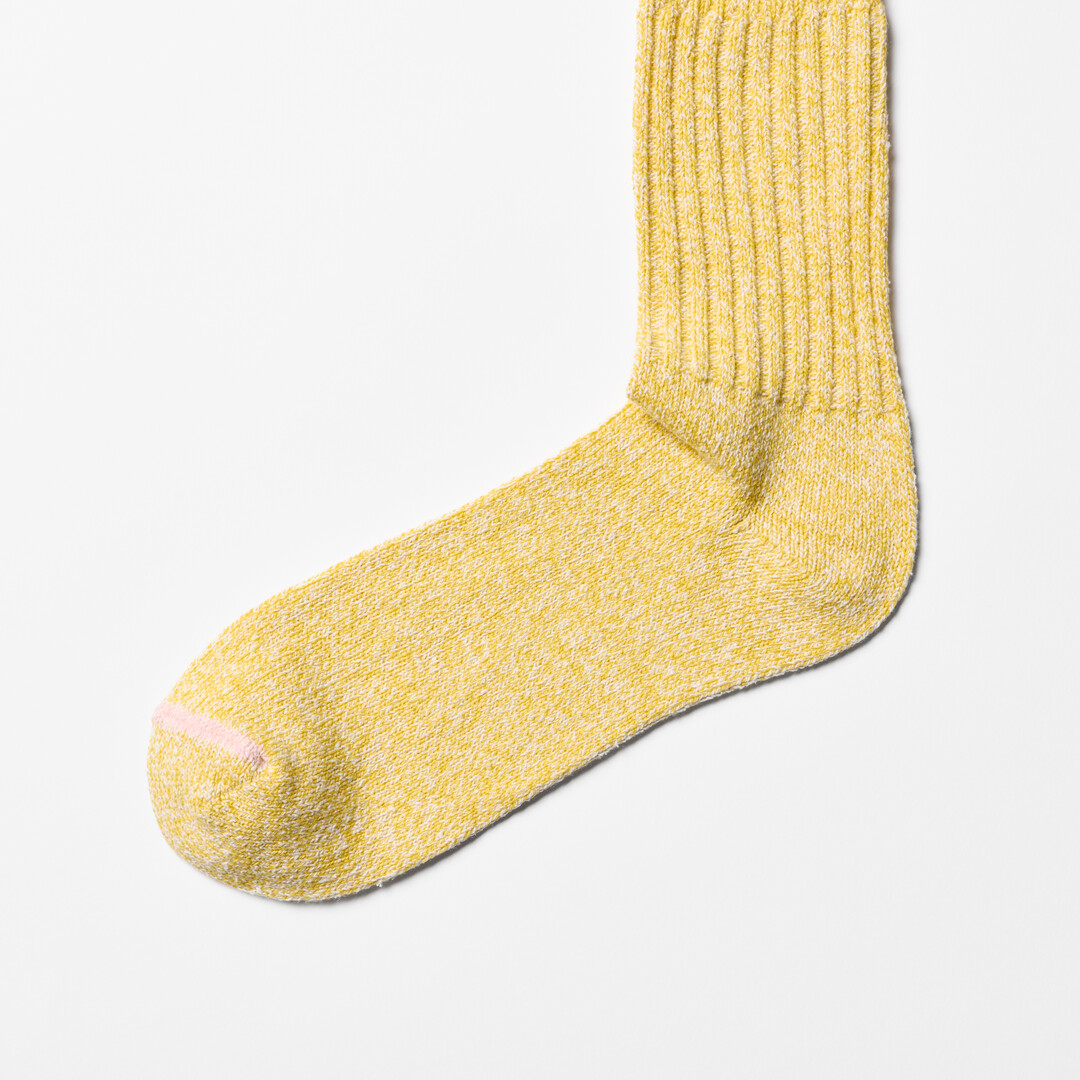 Yellow silk cotton socks with pink trim by Nishiguchi Kutsushita from Japan House London