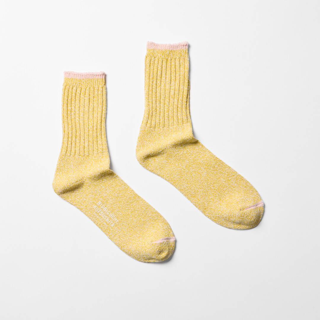 Yellow silk cotton socks with pink trim by Nishiguchi Kutsushita from Japan House London