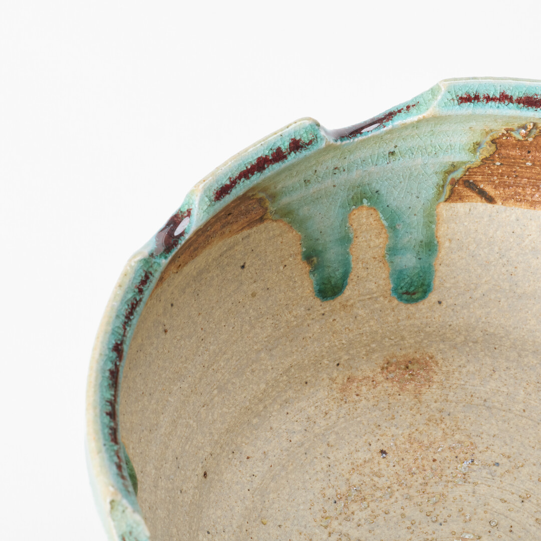 A Shigaraki-yaki plant pot with an uneven edge and hole in the middle from Japan House London