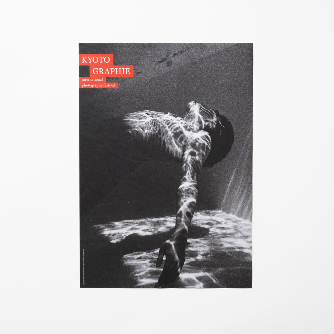 A black and white photo poster of a person floating in water by Kikuji Kawada from Japan House London.