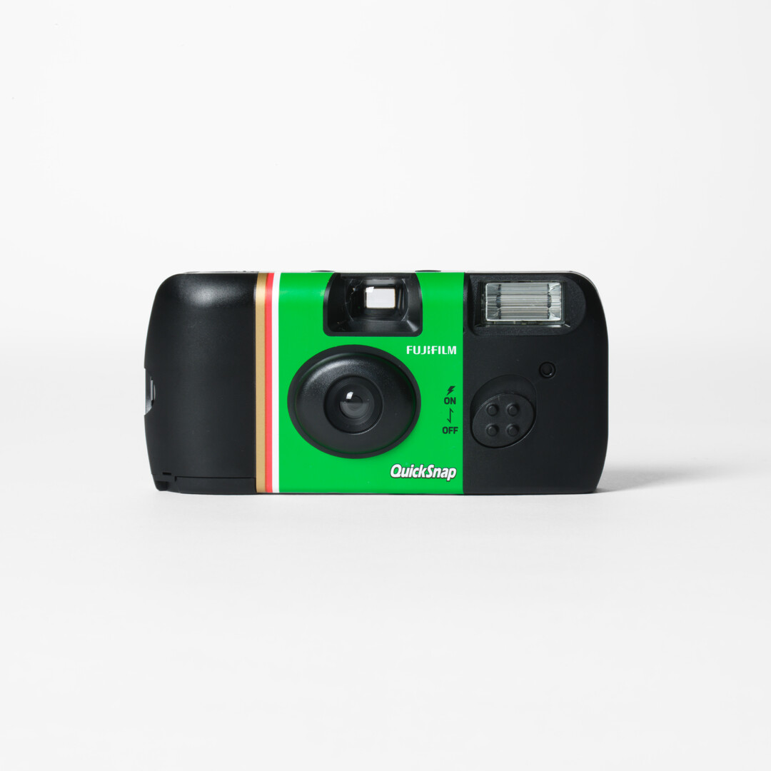 A Fujifilm Quicksnap Single Use Camera with black and green body from Japan House London.