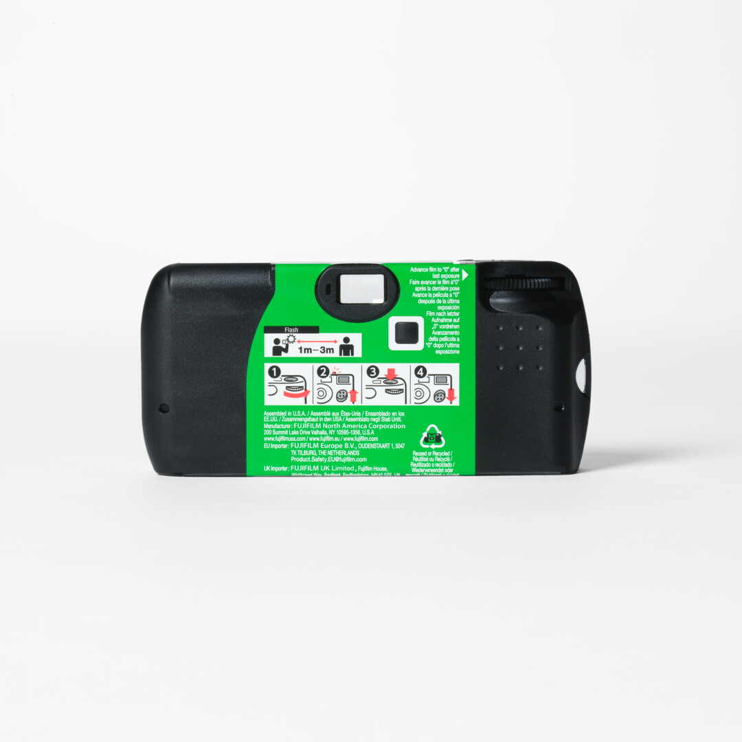 A Fujifilm Quicksnap Single Use Camera with black and green body from Japan House London.