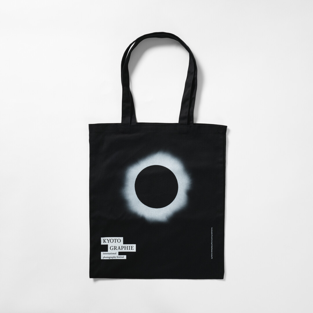 Black tote bag with the Kikuchi Kawada's photograph of the eclipse from Japan House London.
