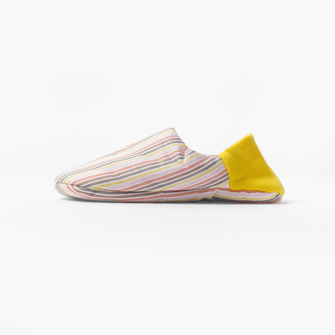 Pick Stripe Knapsack Merippa Slippers with pink and brown stripes on beige background and yellow heel from Japan House London.