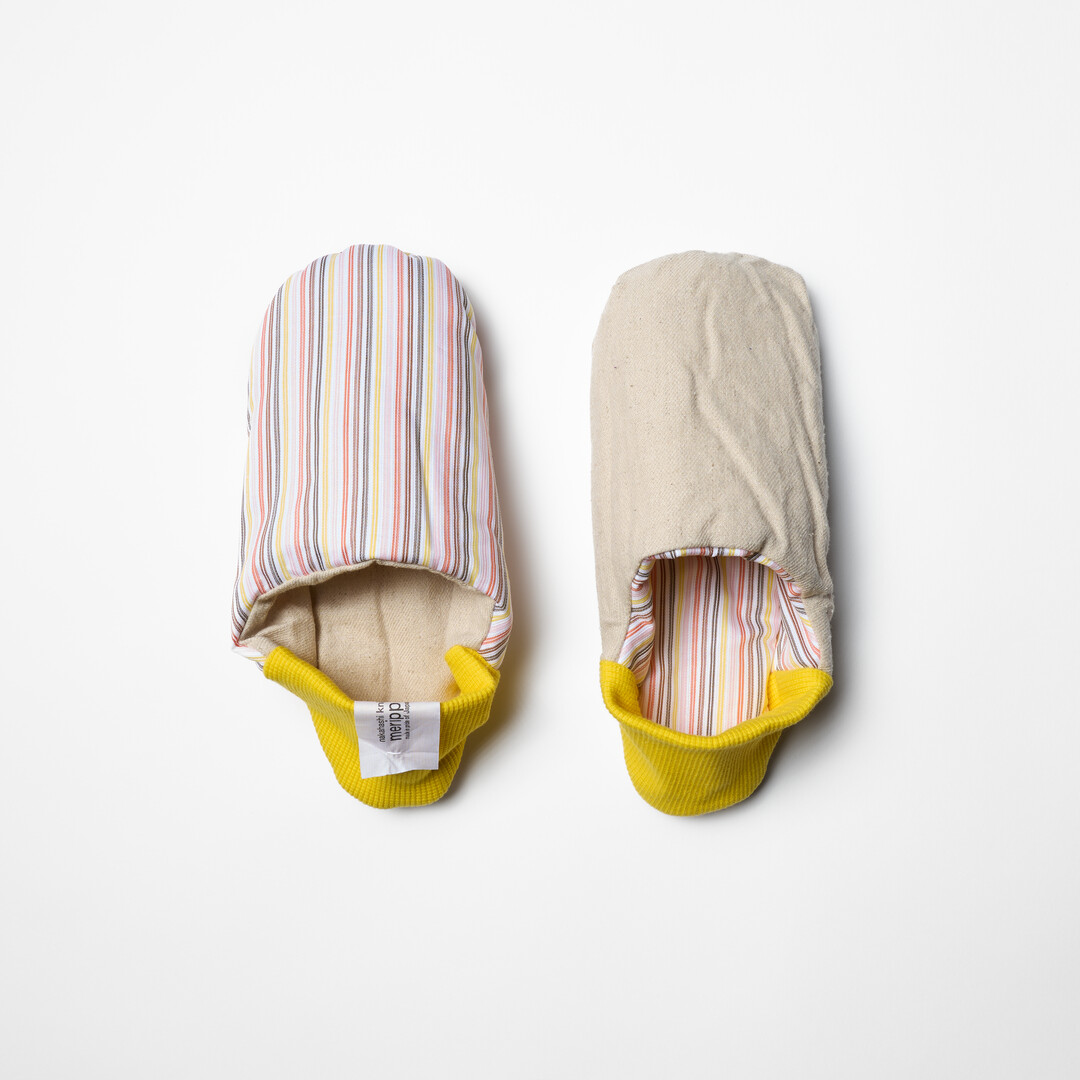 Pick Stripe Knapsack Merippa Slippers with pink and brown stripes on beige background and yellow heel from Japan House London.