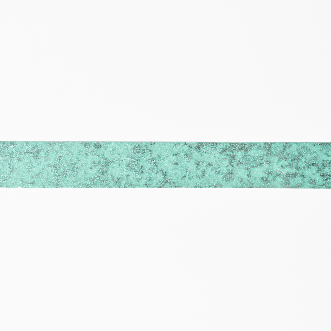 Washi tape with a light green background with a metalic pattern that creates an eye-catching sheen from Japan House London.