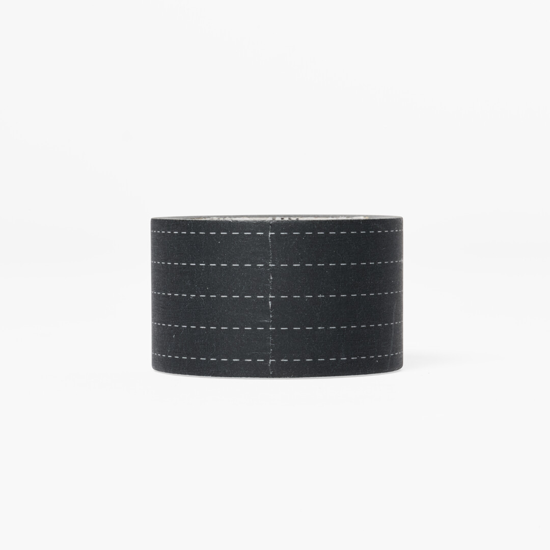 Washi tape with white dotted lines with black background design for writing and drawing on from Japan House London.
