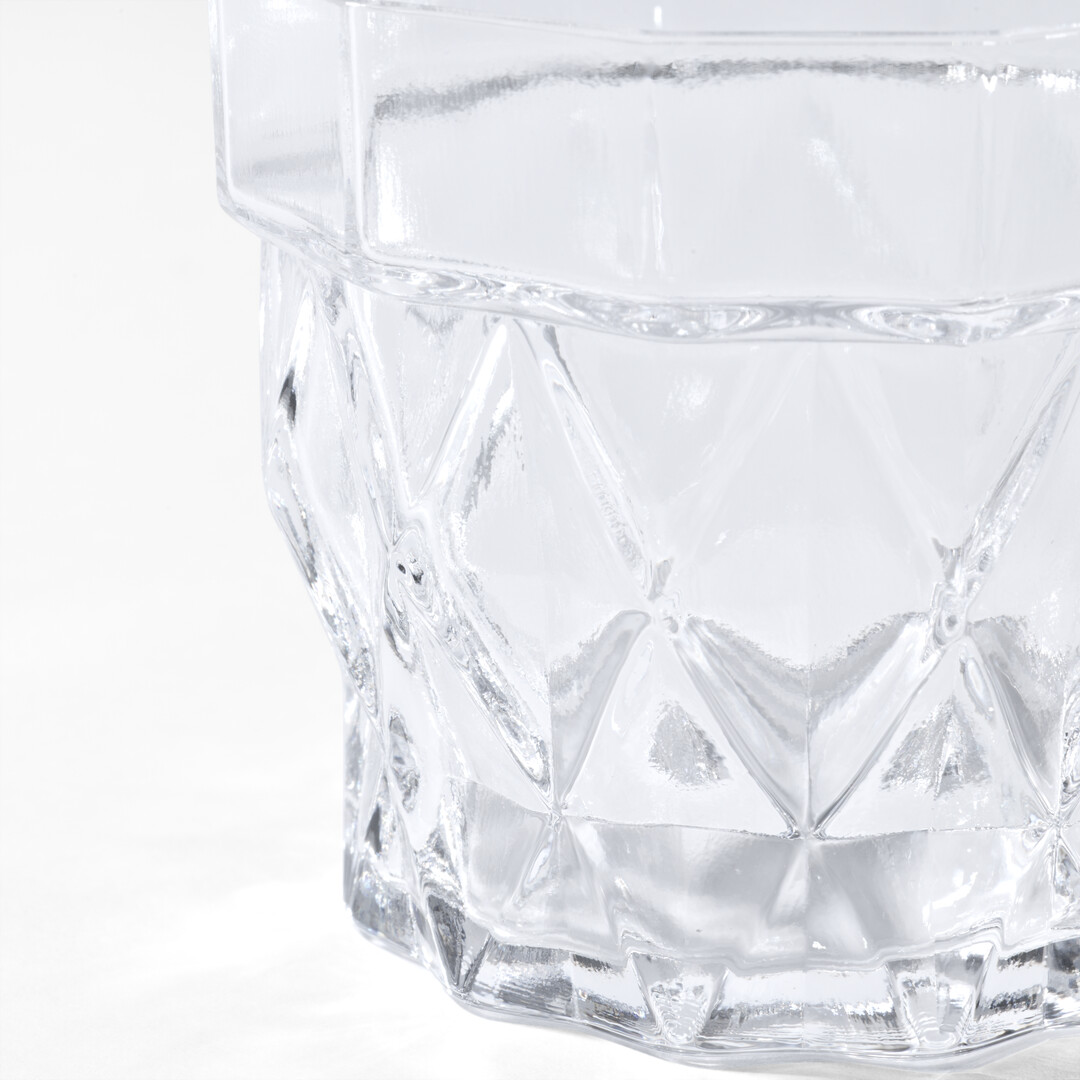 Whisky Glass Stium in glass with a patterned wall from Japan House London.