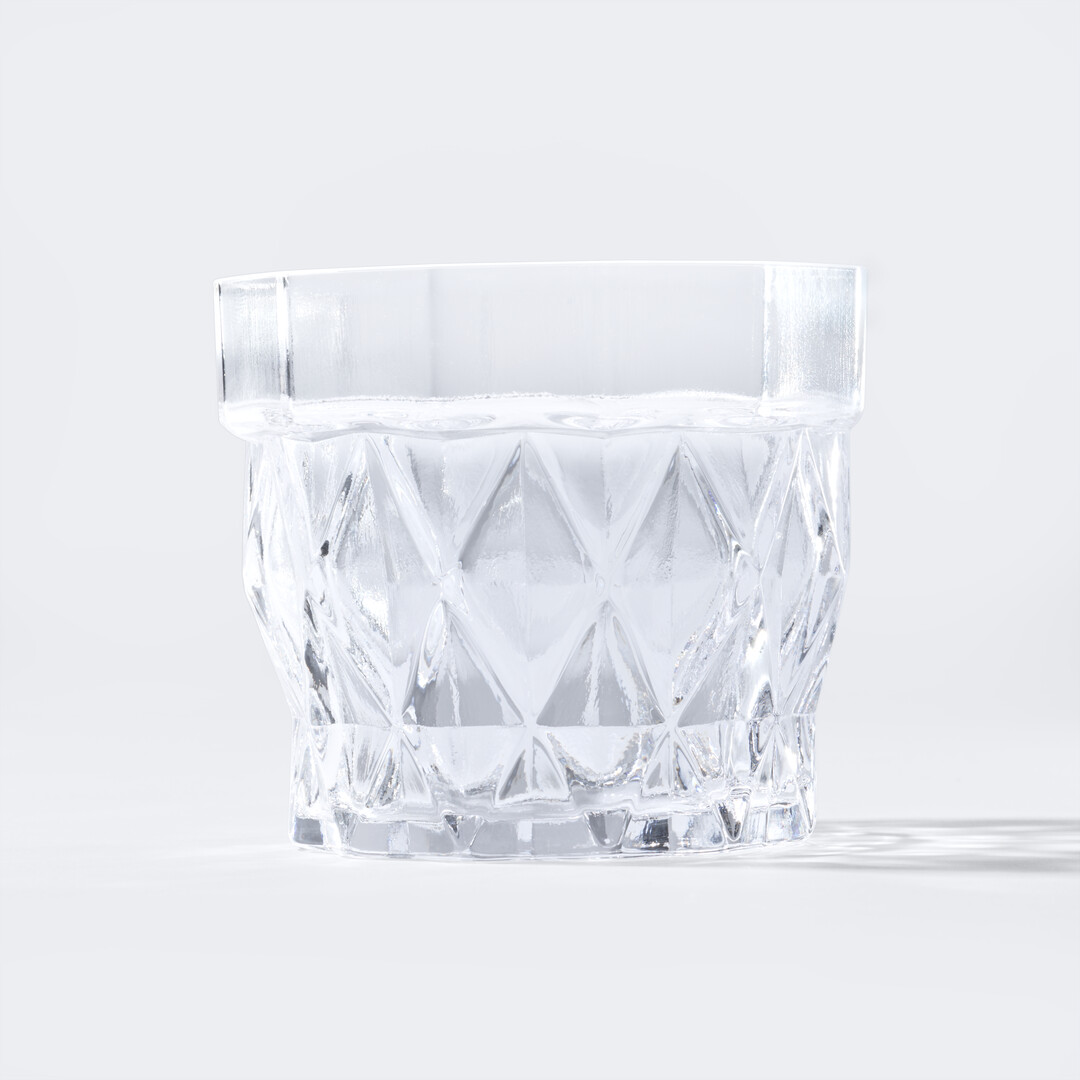 Whisky Glass Stium in glass with a patterned wall from Japan House London.