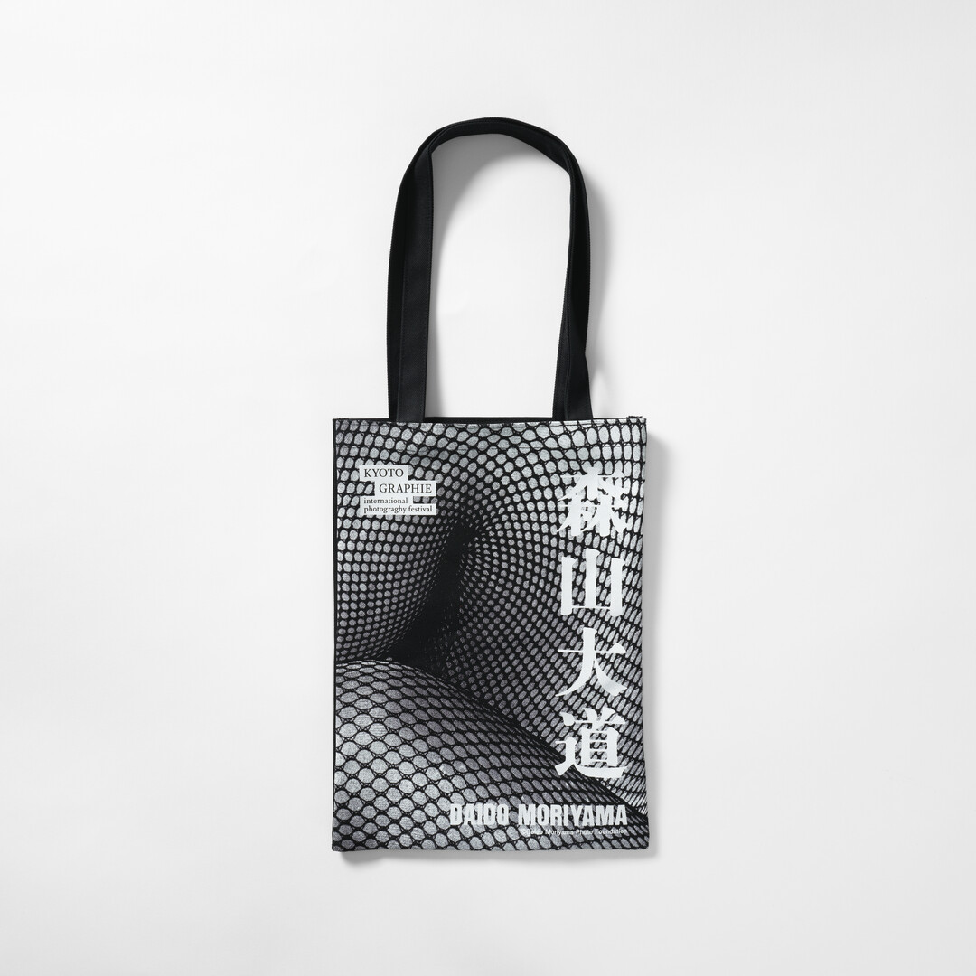 A black tote bag with Moriyama Daido's photography and name in white from Japan House London.