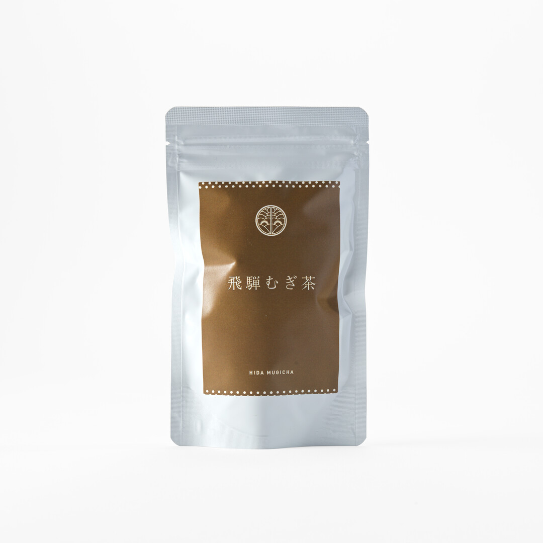 A silver bag holding Nabeshima Meicha Barley tea bags from Japan House London