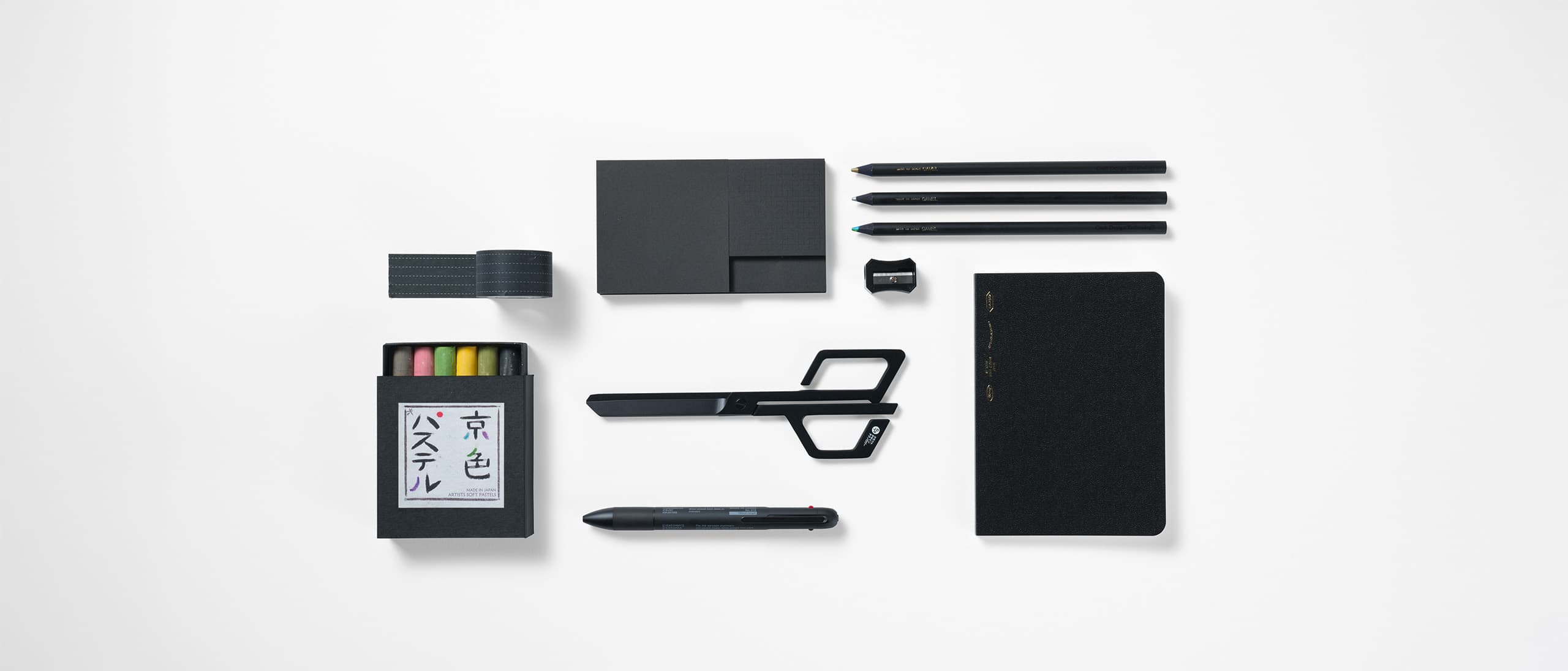 A selection of stationery in black in a rectangular formation from Japan House London.