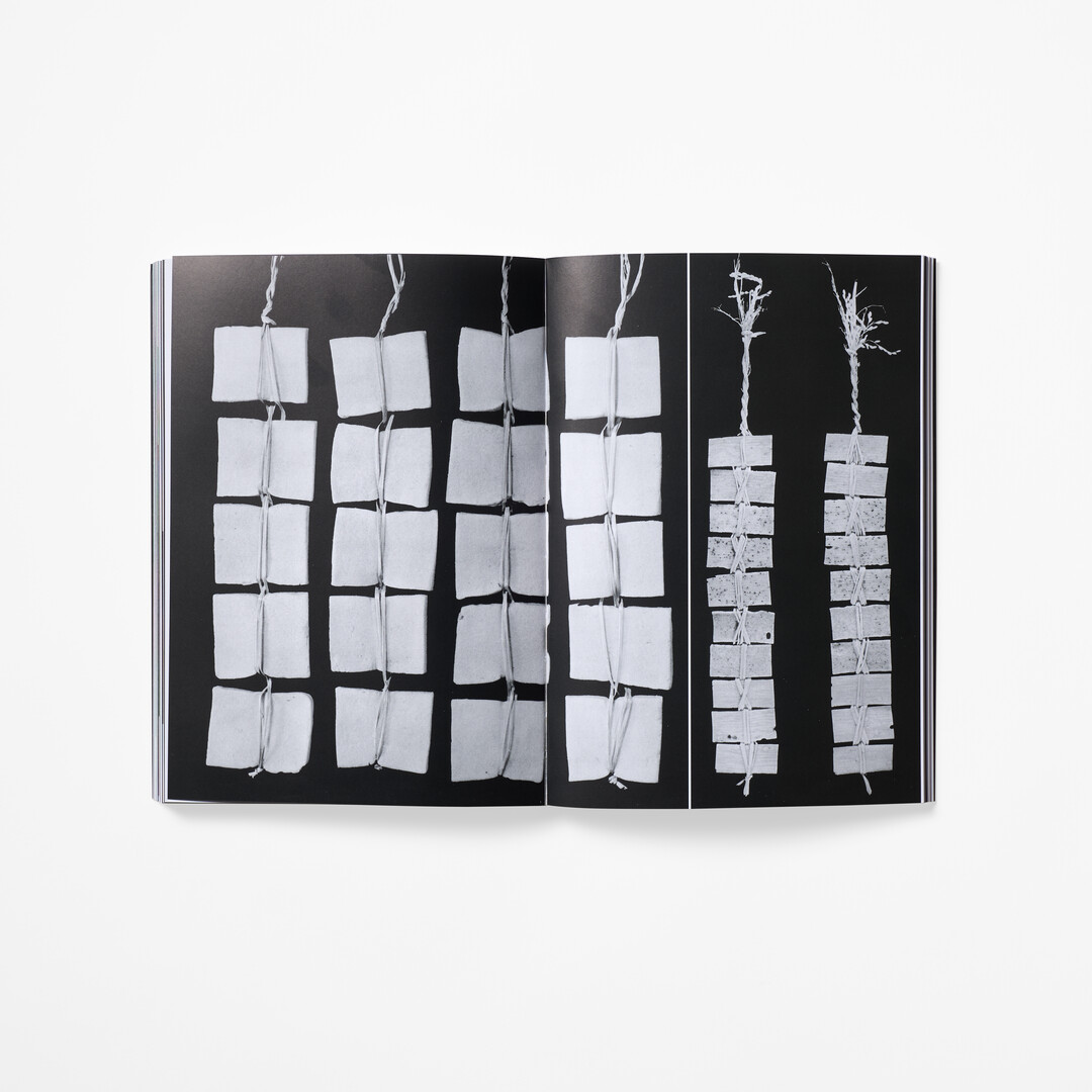 A spread with black and white photographs from the book How to Wrap Five Eggs from Japan House London.