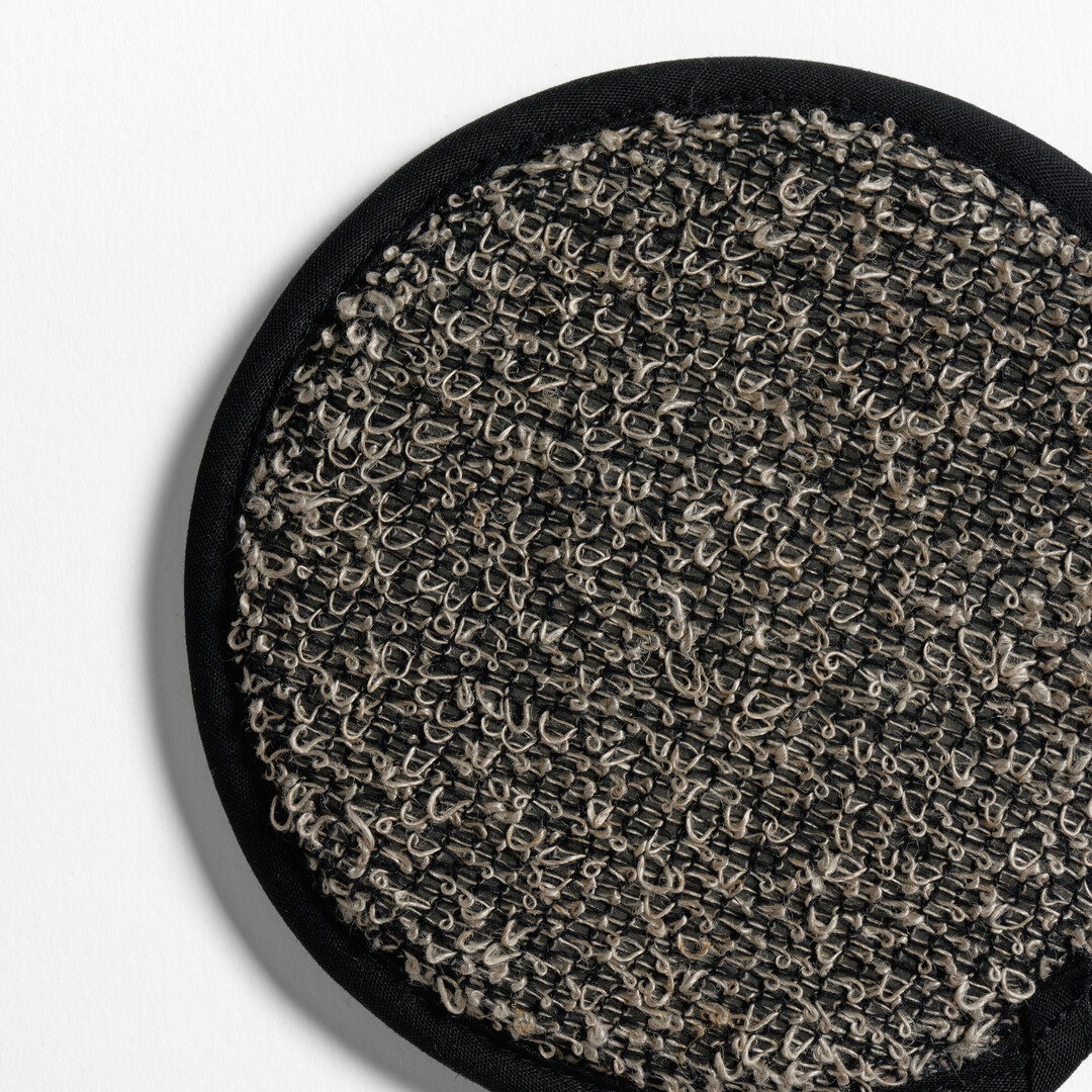 A grey, circular cotton linen blend scrub wash by Kiyoi, from Japan House London.