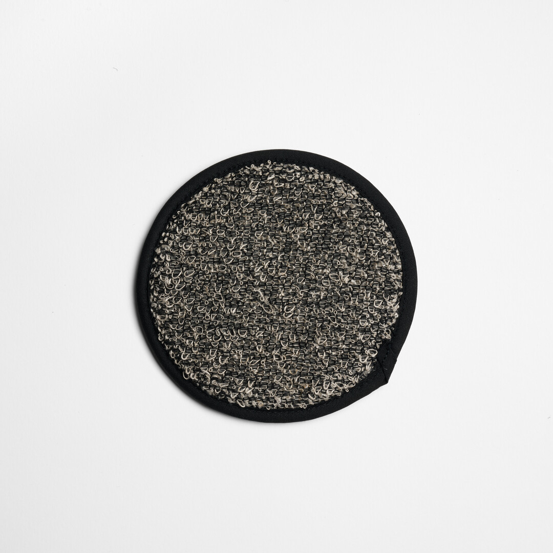 A grey, circular cotton linen blend scrub wash by Kiyoi, from Japan House London.
