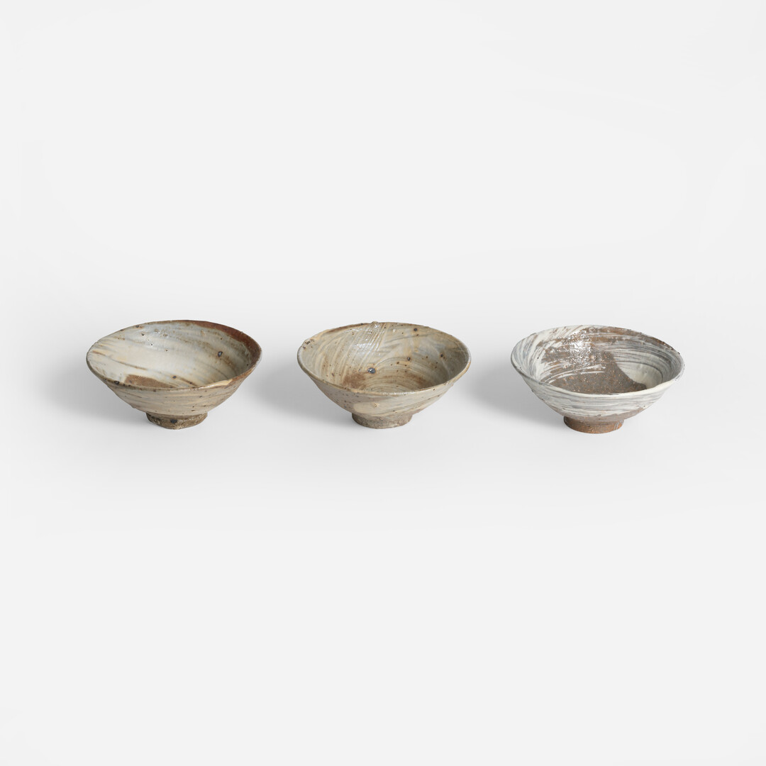 Three Tatsumi Koishiwara Ceramic Bowl - Hakeme Brushed Slip in a row from Japan House London.