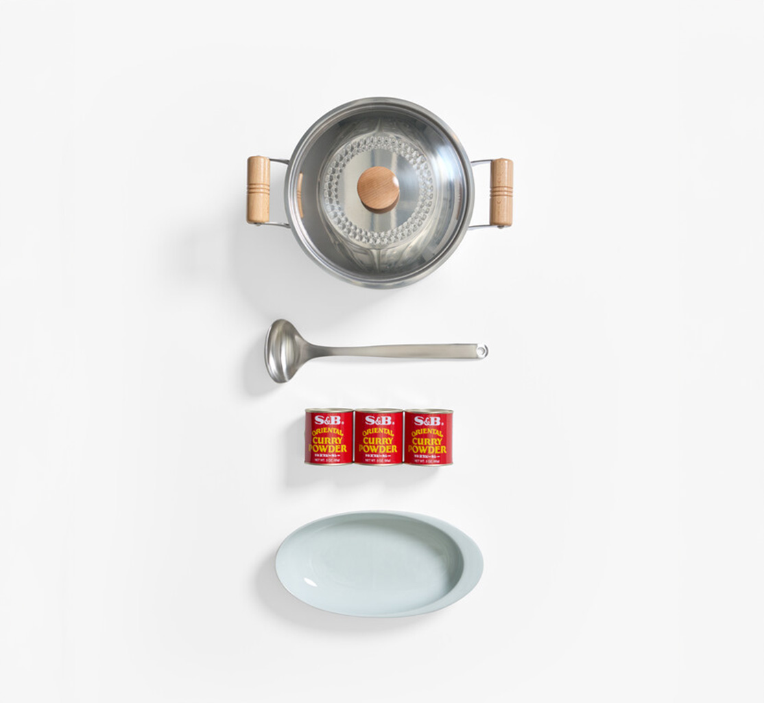Stainless steel pot with ladle three cans of S&B spice and a curry bowl from Japan House London.